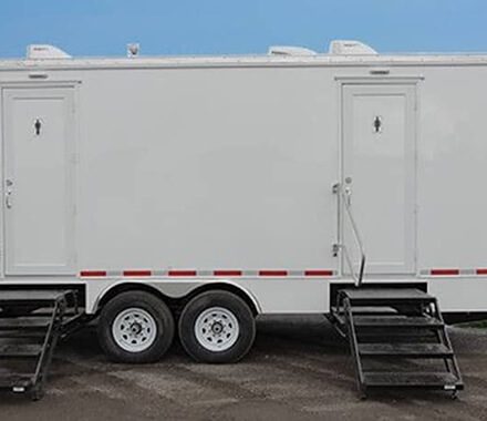 Luxury restroom trailer setup at a scenic campground